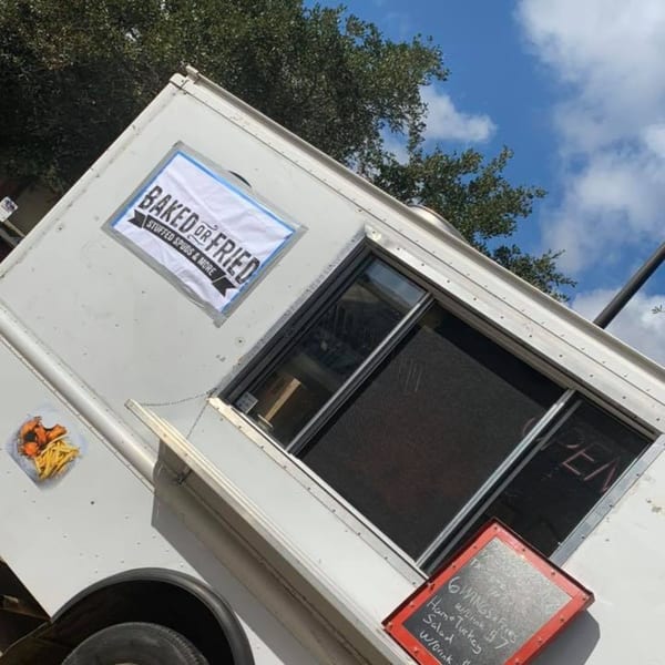 Baked or Fried food truck with a menu board and "OPEN" sign in the window.