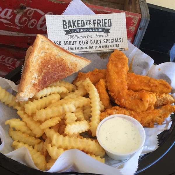 A basket of Baked or Fried chicken tenders, crinkle-cut fries, grilled cheese, and a side of ranch.